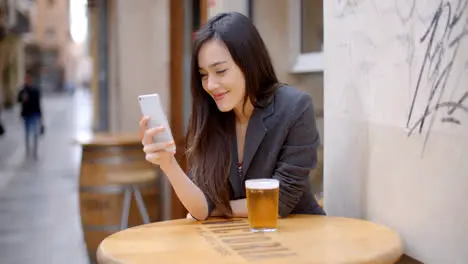 Smiling young woman relaxing with a beer