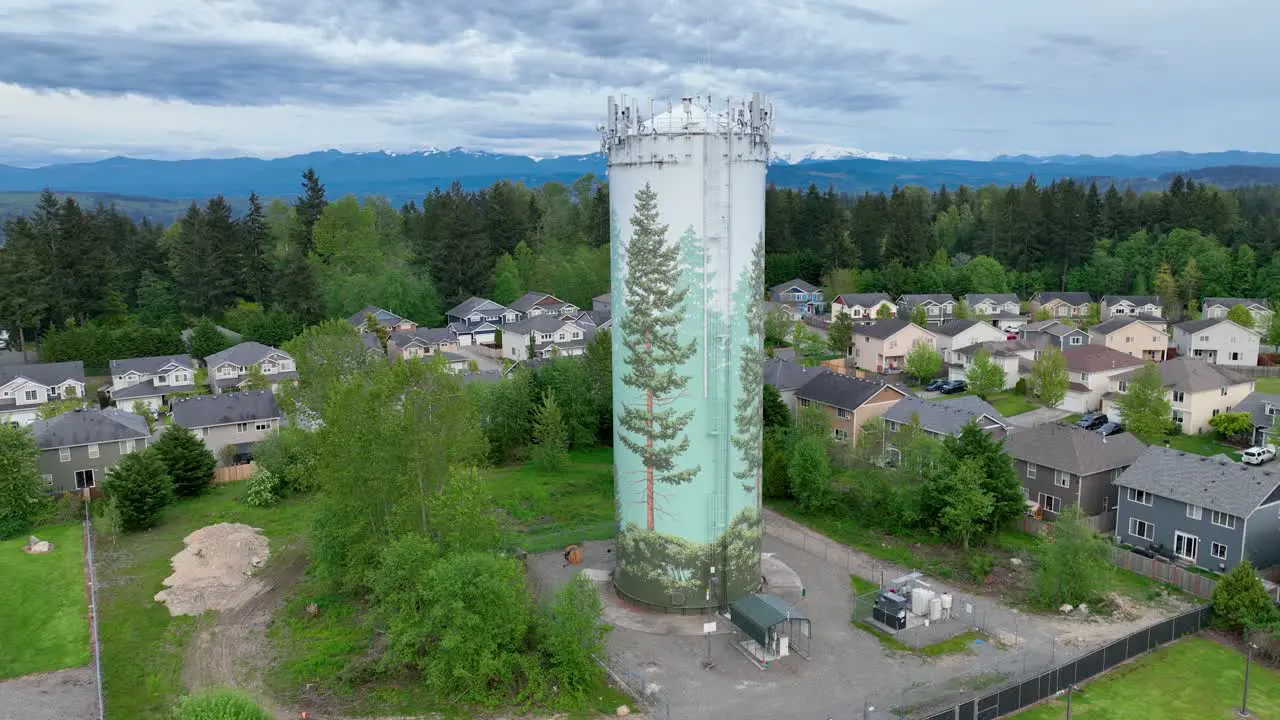 Aerial shot of a water tower surrounded by a suburban neighborhood