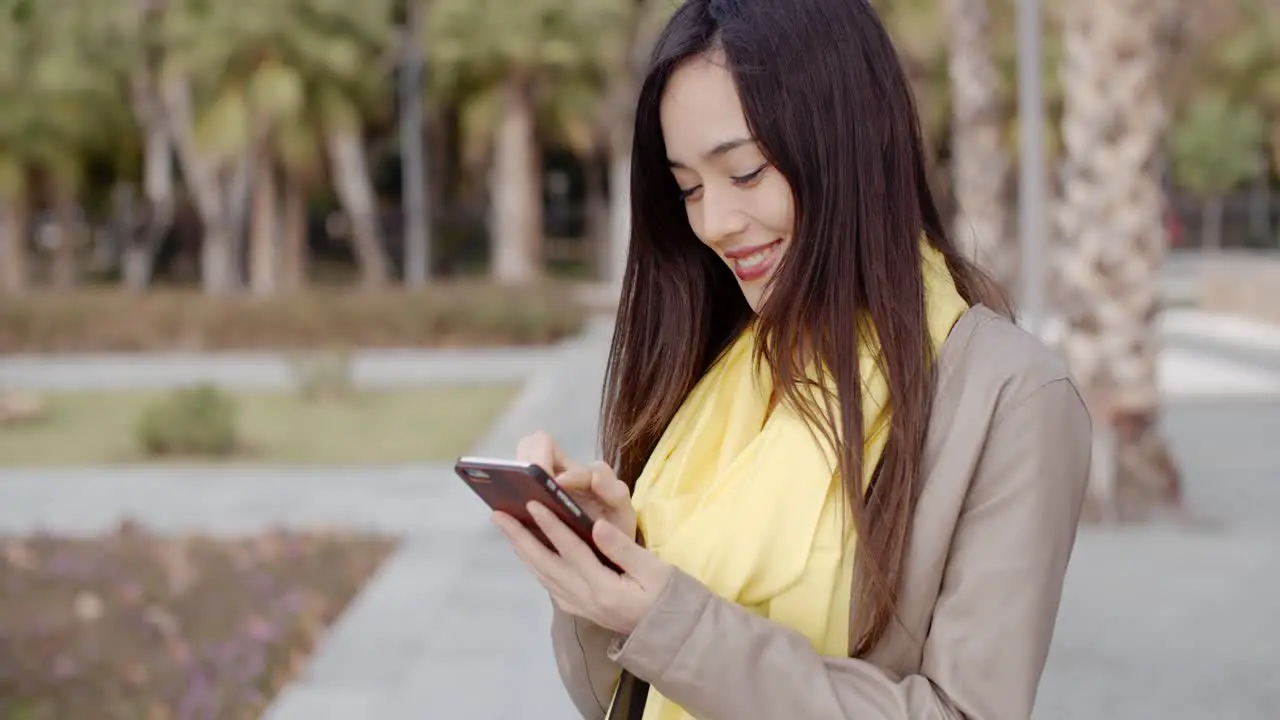 Stylish woman checking a message on her mobile