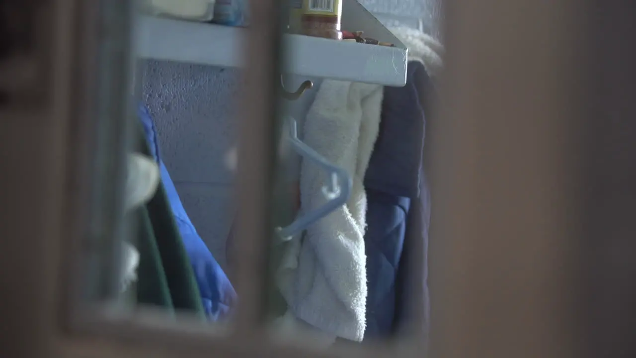 Prisoner clothing in cellblock housing unit behind bars prison jail