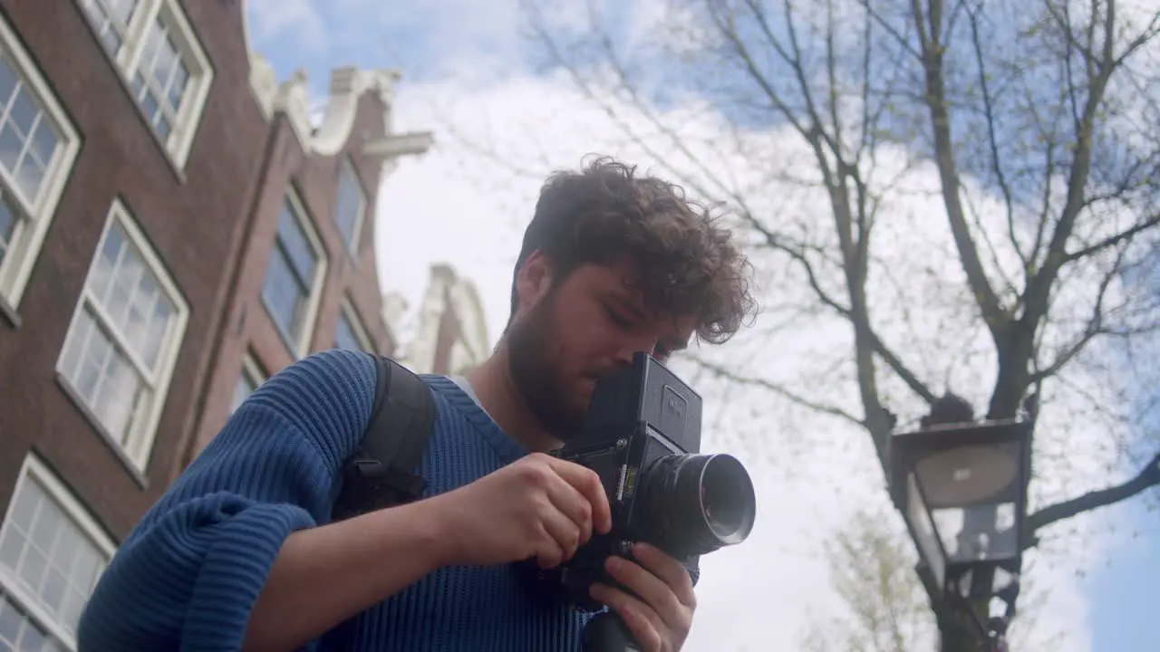 Portrait Of An Outdoor Photographer With Analog Film Camera In Amsterdam Netherlands