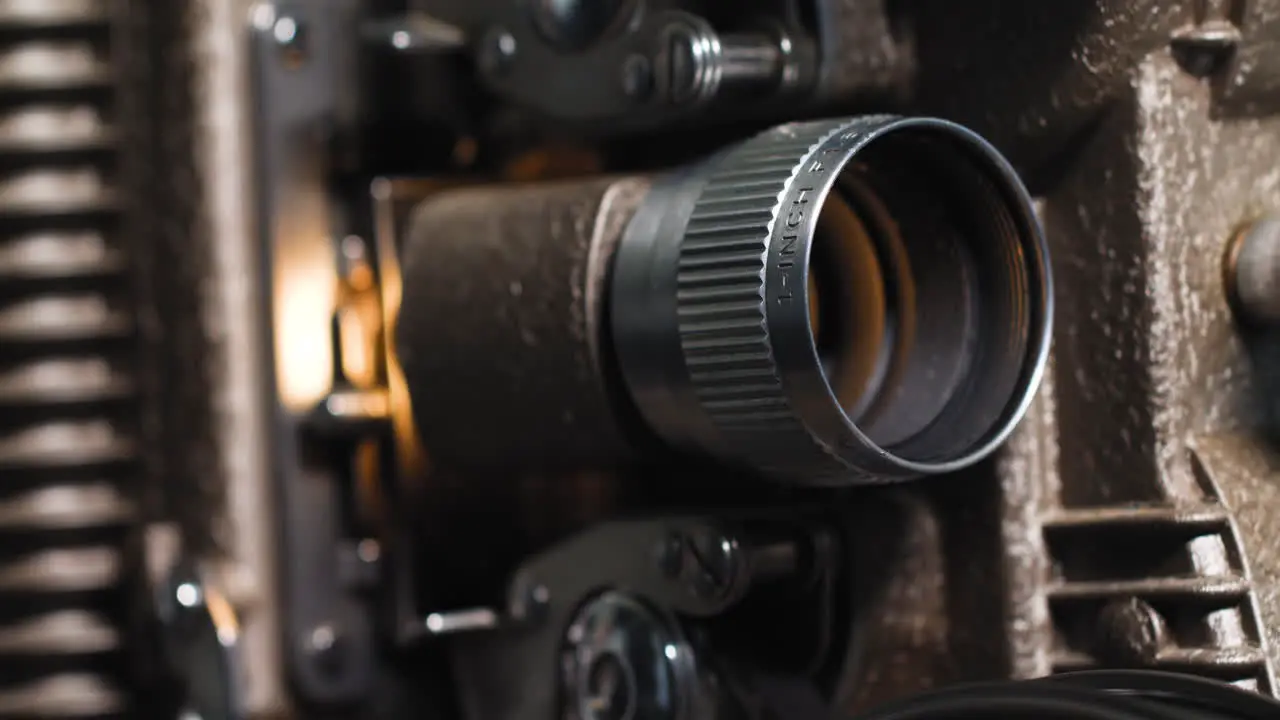 Macro close up of 8mm film strip tape going through an old vintage analog 8mm projector