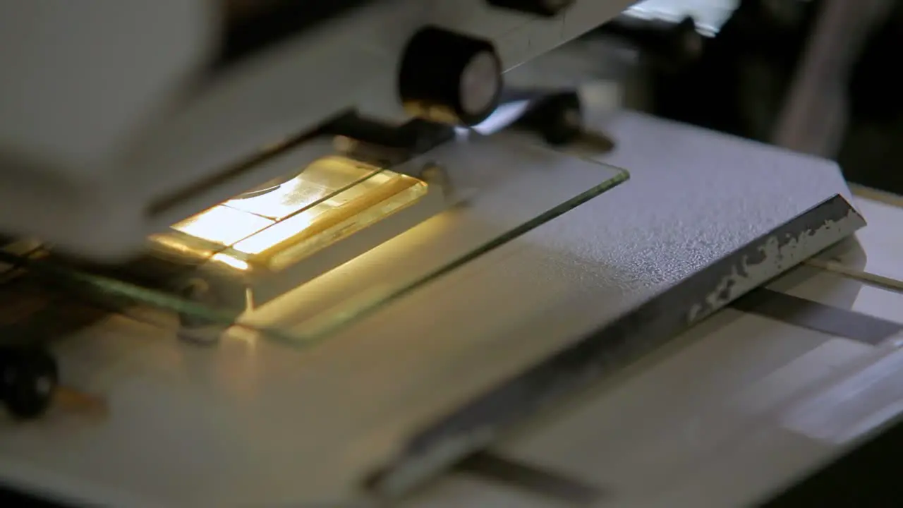 person doing a research in a old fashion microfilm machine