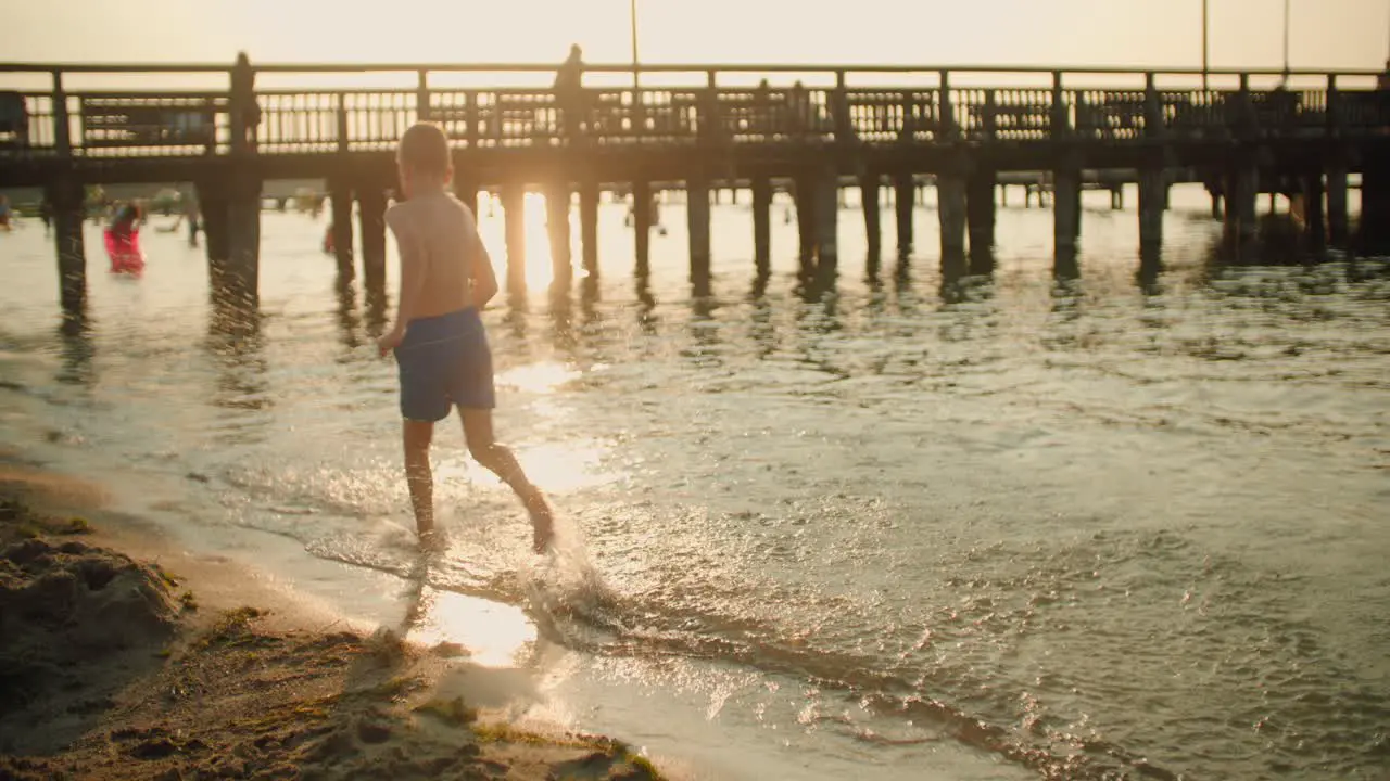 Kid running on the beach slow motion