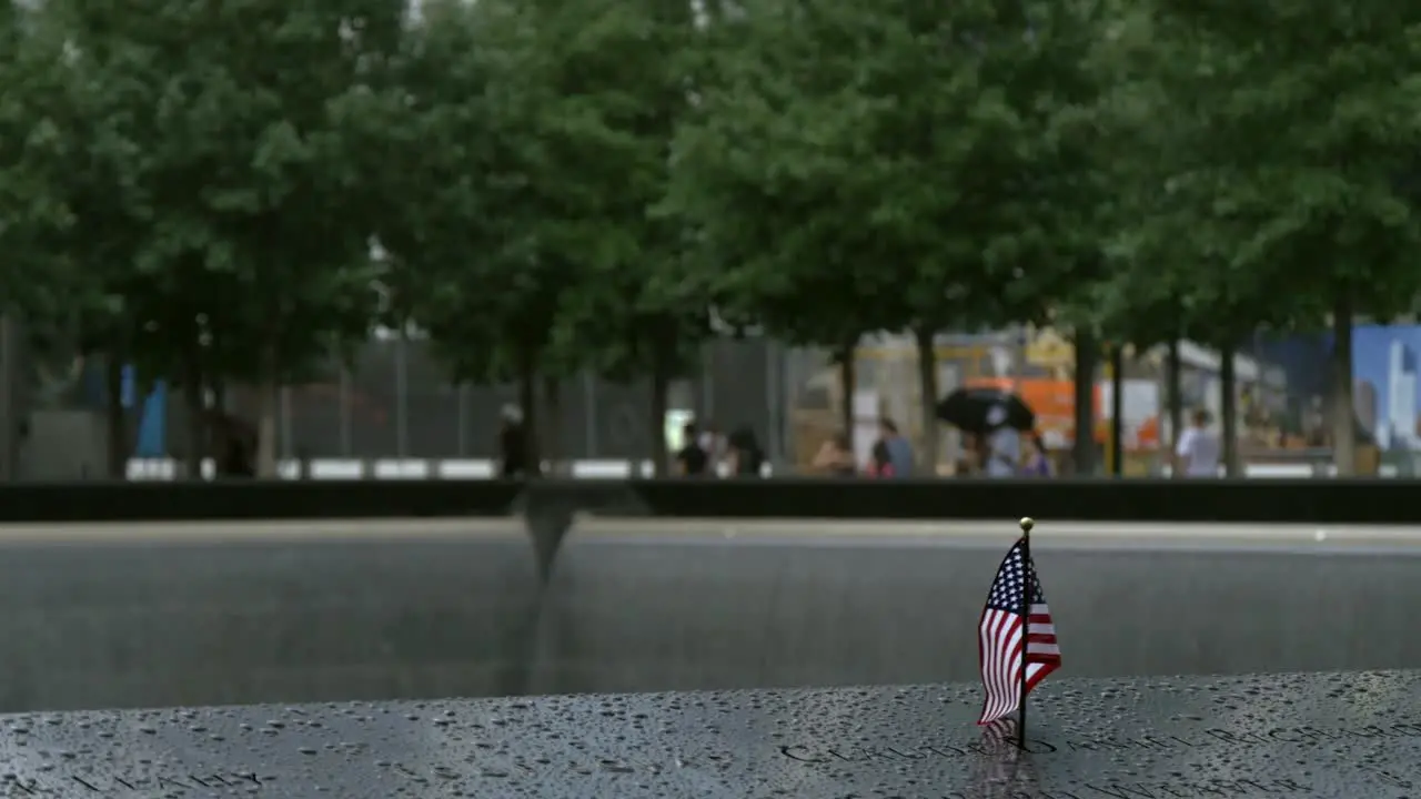 USA Flag in 911 Memorial Plaque in Rain