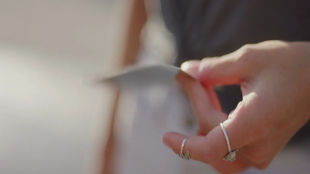 Young Female Hand Fans Polaroid Film to Expose Slow Motion Close Up