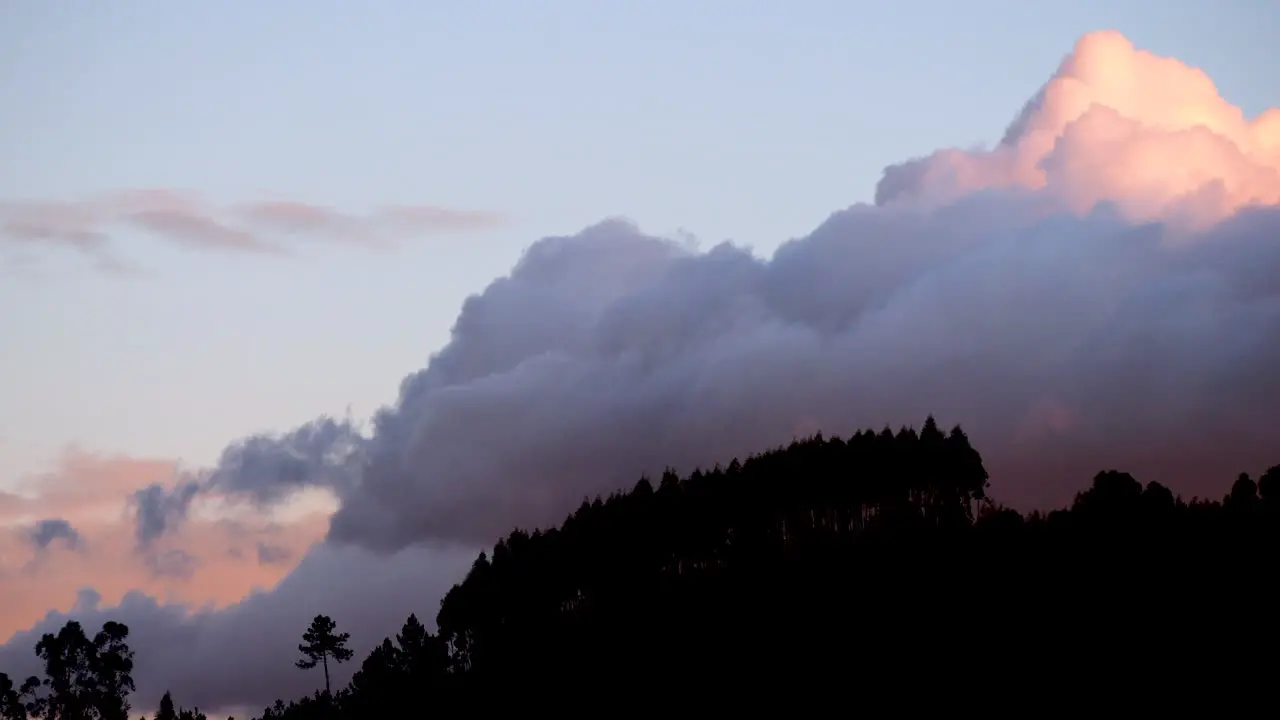 Timelapse of Winter clouds forming on a mountain at sunset