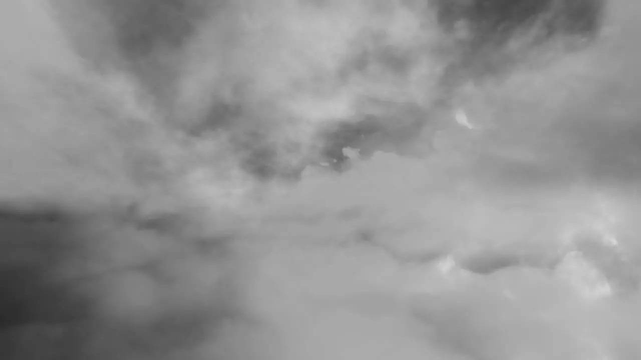 time lapse flying through white clouds and thunderstorms