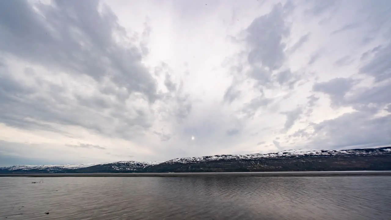 Clouds flying above the icy lake