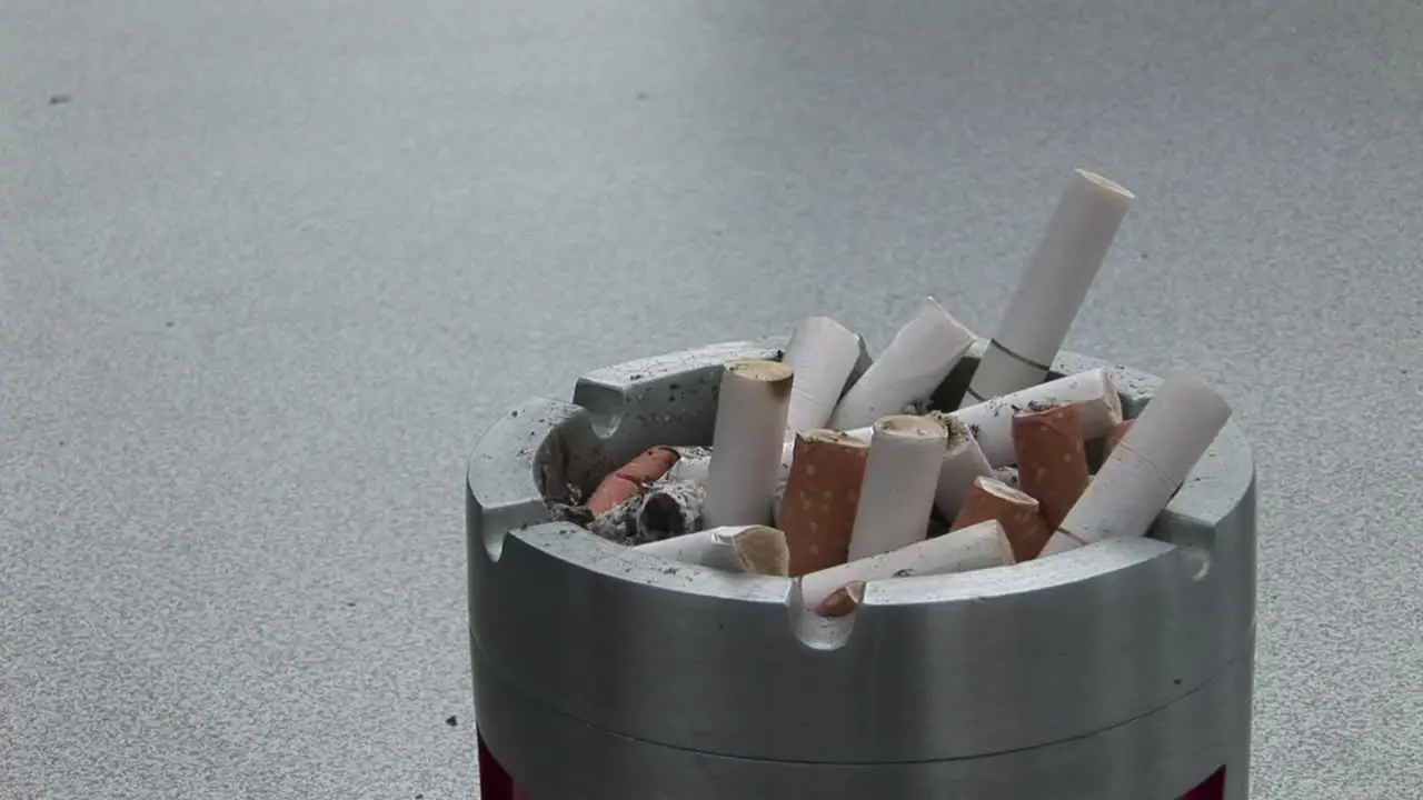 Putting out Cigarette in Ash Tray 