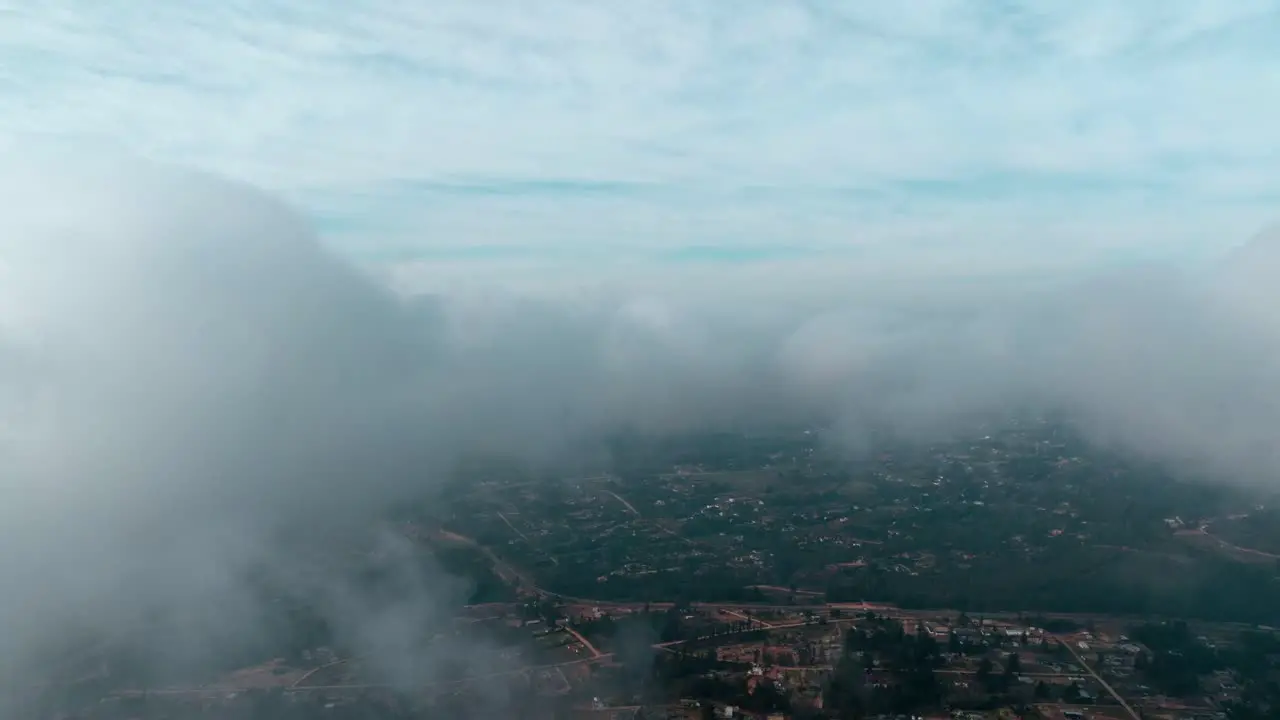 Aerial view dolly in of a flight through the clouds passing through