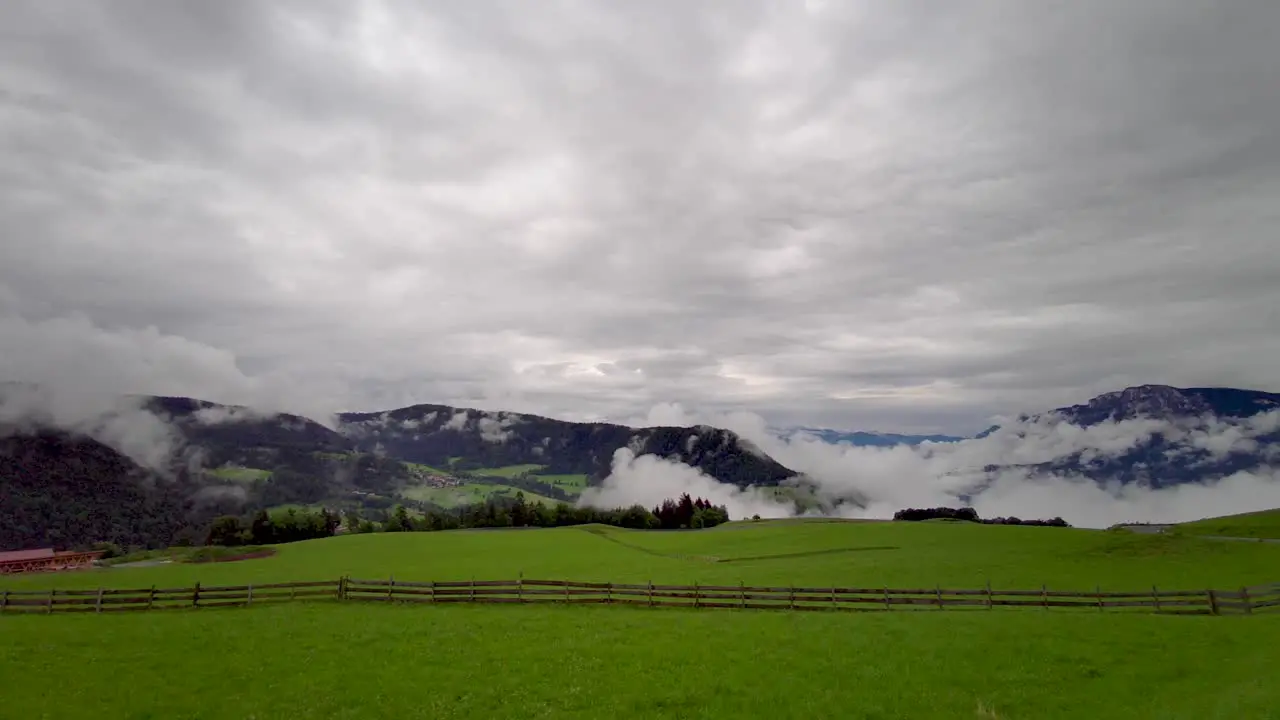 A field with a very cloudy sky