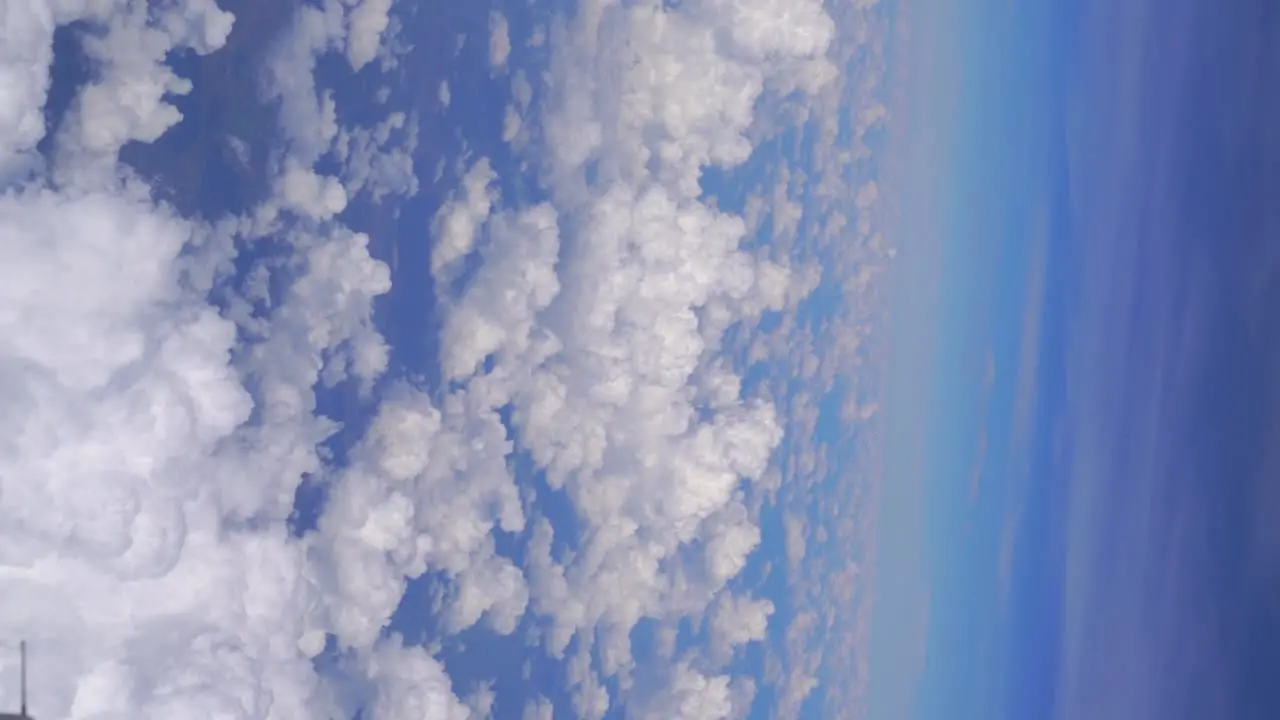 Vertical view over beautiful fluffy clouds against blue sky