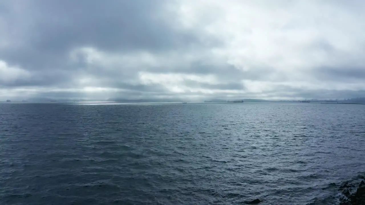 Skies and natural shoreline with clouds and slight rain