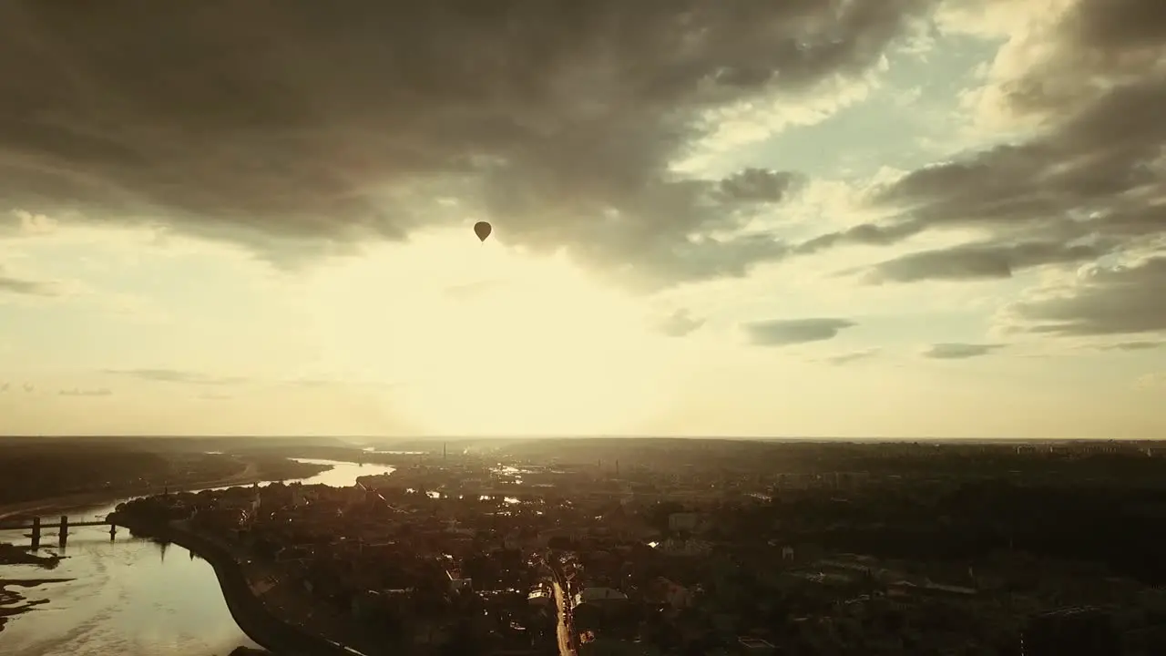 Aerial view of hot air balloon in the cloudy sky above the Kaunas old town