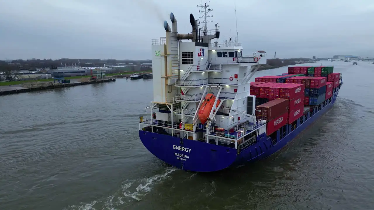 Aerial Shot Around Stern Of Energy Cargo Ship Carrying Viasea Intermodal Containers Passing Along Oude Maas