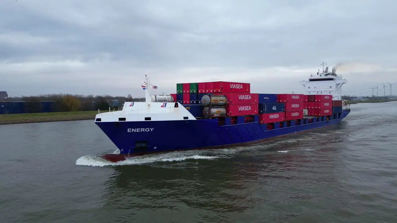 Aerial Off Port Side Of Energy Cargo Ship Carrying Viasea Intermodal Containers Navigating Along Oude Maas