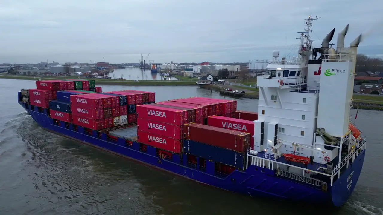  Energy Cargo Ship Carrying Viasea Intermodal Containers Passing Along Oude Maas On Cloudy Day