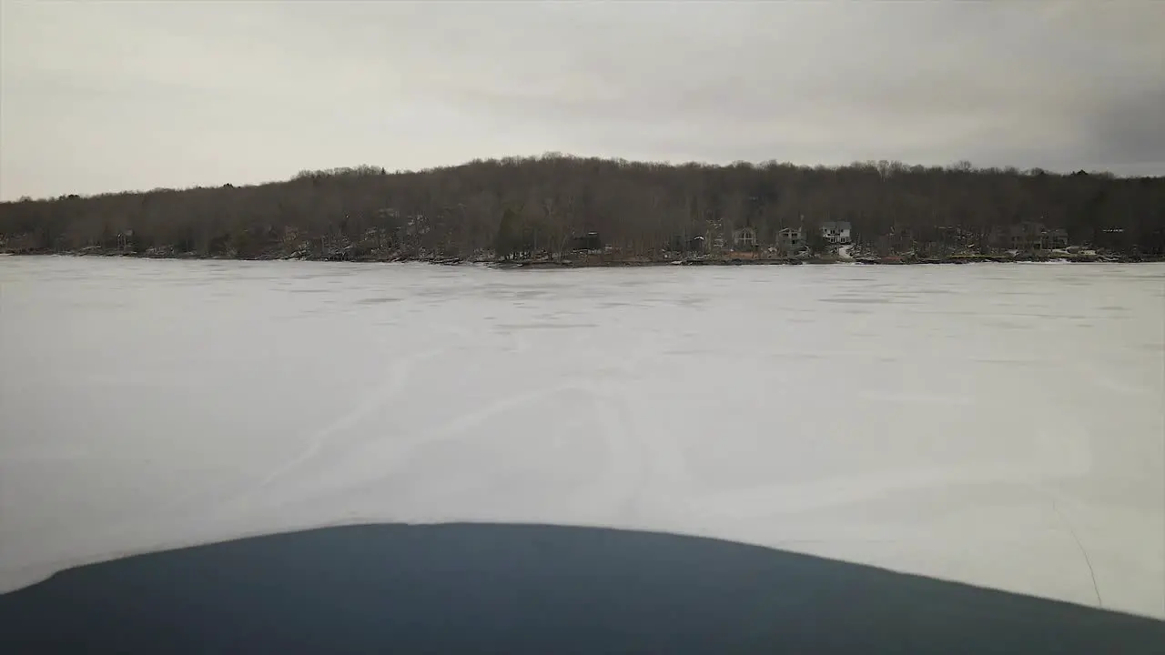 Geese swimming in a frozen lake in the Pocono Mountains during winter