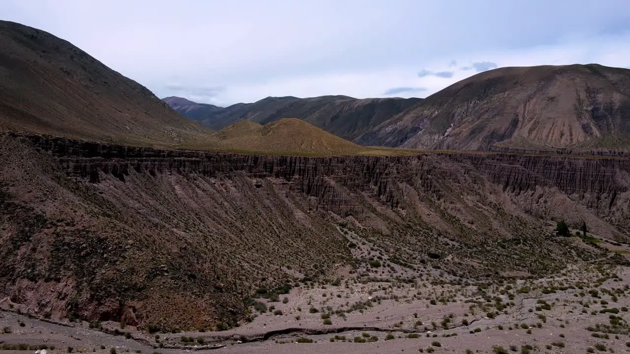 Drone shot flying towards a rugged cliff in Jujuy Argentina