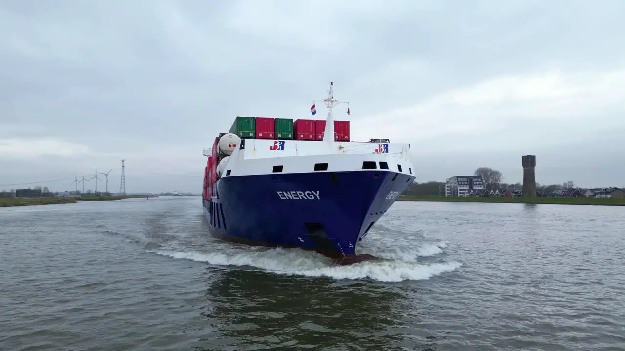 Aerial Flying Close Around Forward Bow Of Energy Cargo Ship Carrying Viasea Intermodal Containers Sailing Along Oude Maas