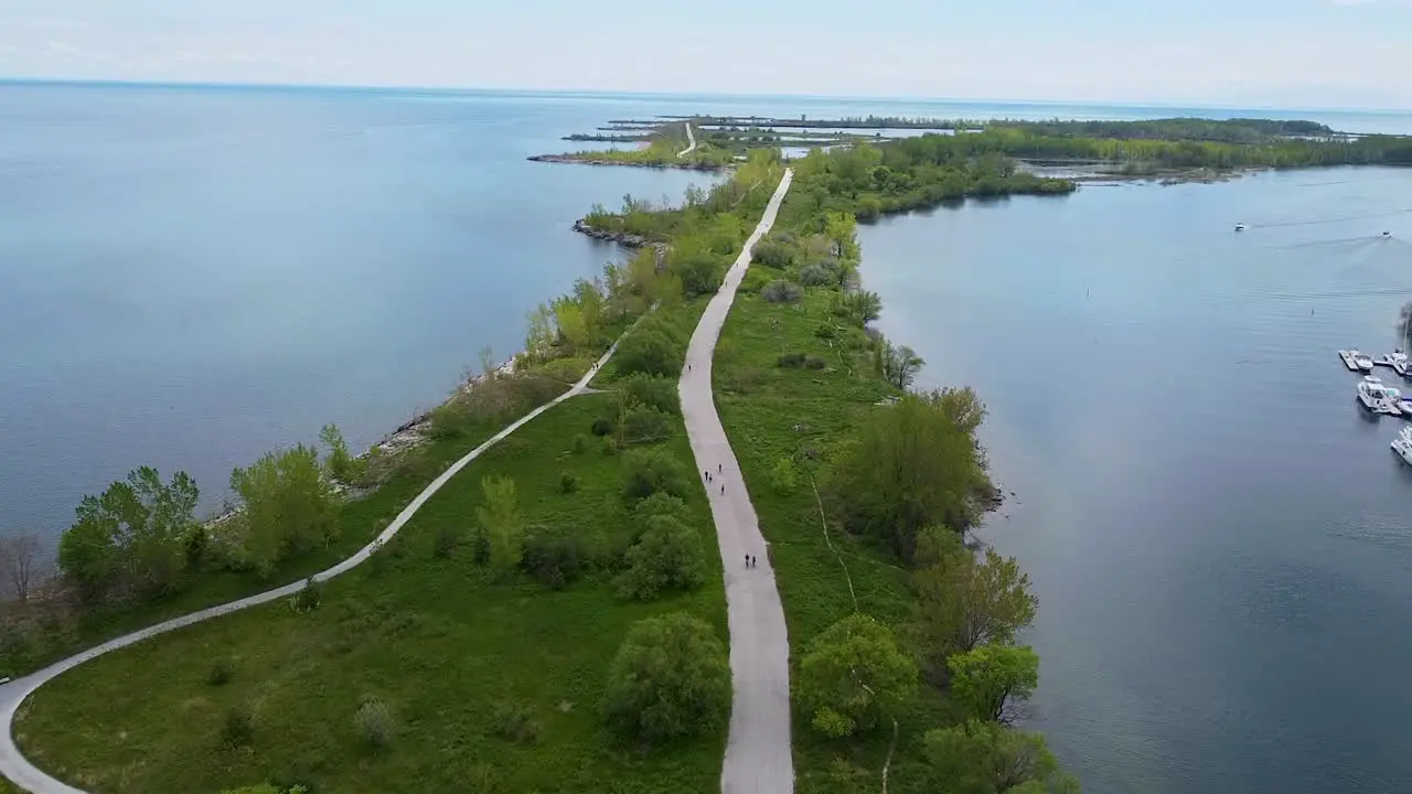 Aerial shot of bike path surrounded by water slow push in