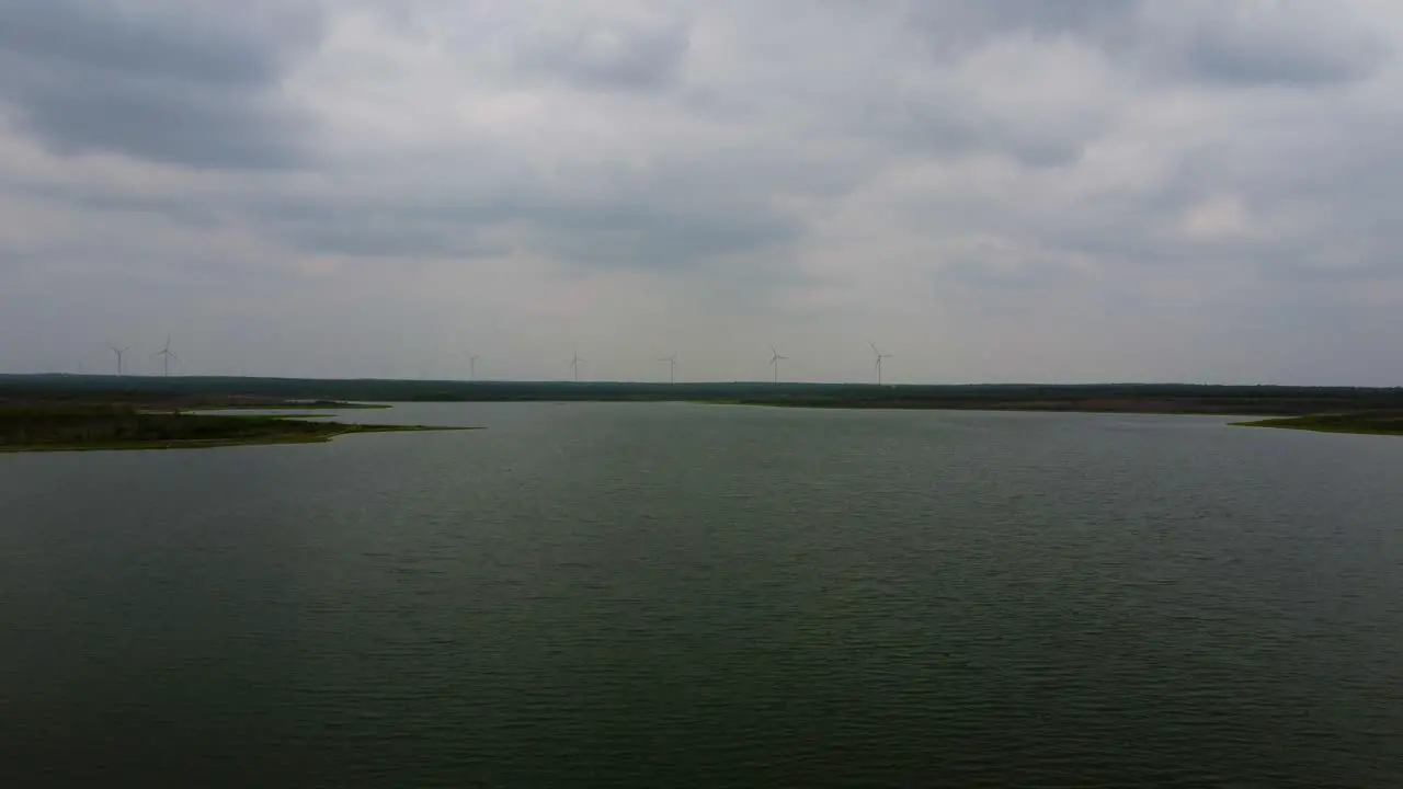 Flying over falcon lake towards the windmills