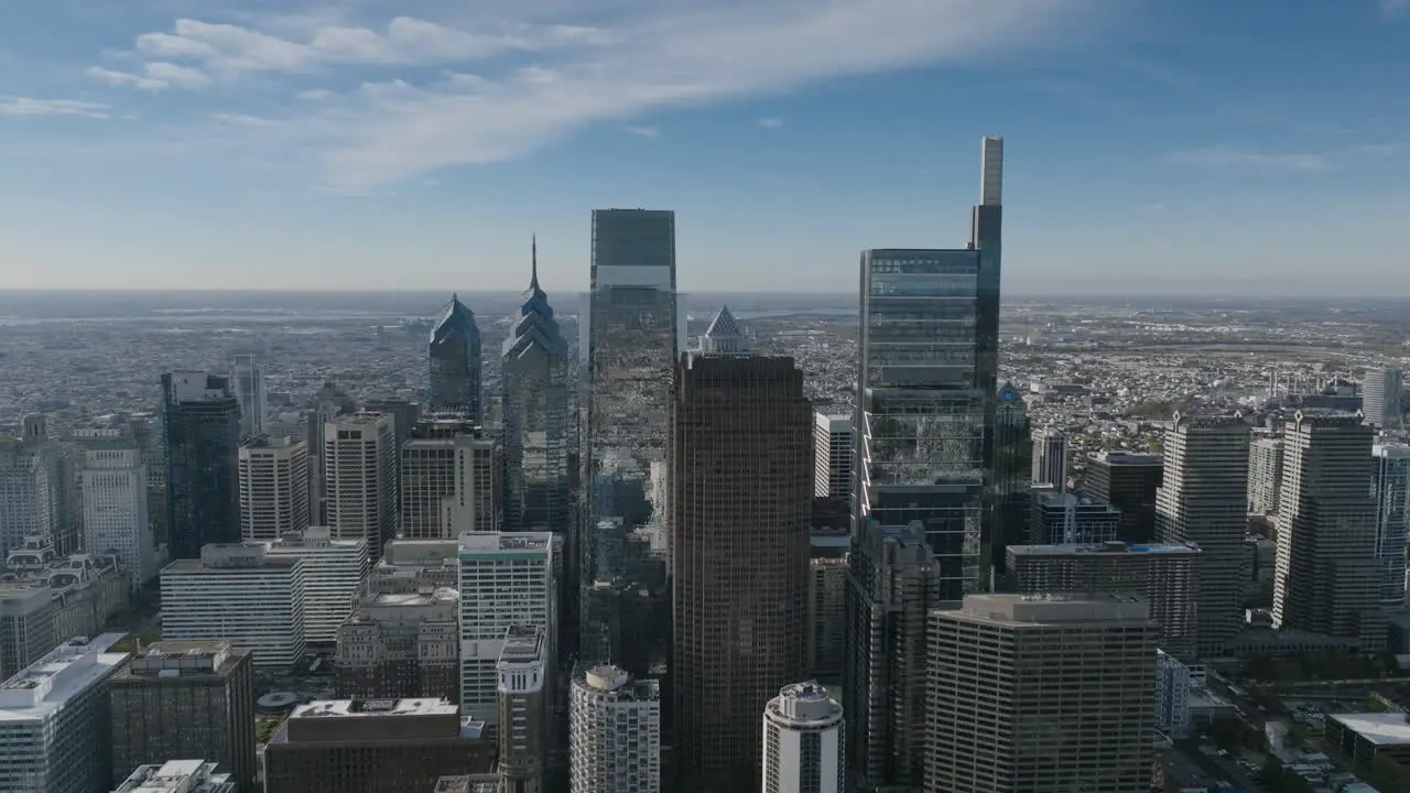 Wide aerial footage flying away from the skyscrapers in downtown Philadelphia in the morning