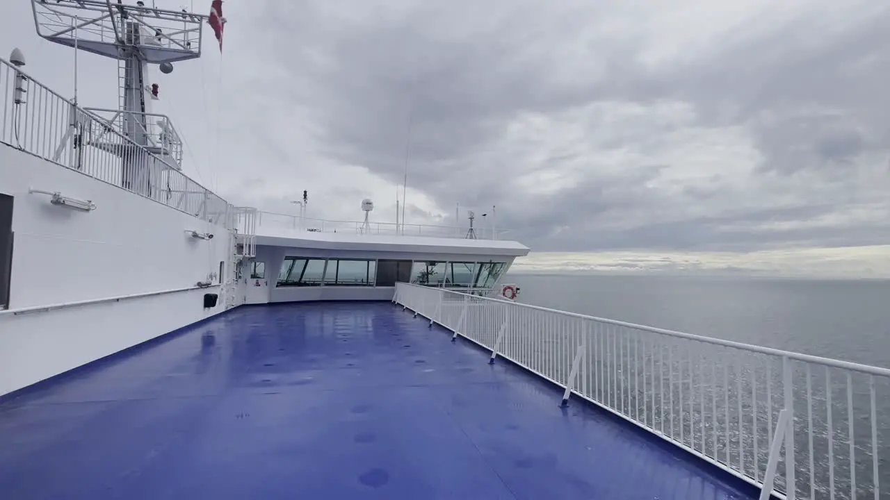 empty persone deck of a car ferry on the sea in the wind under a cloudy sky