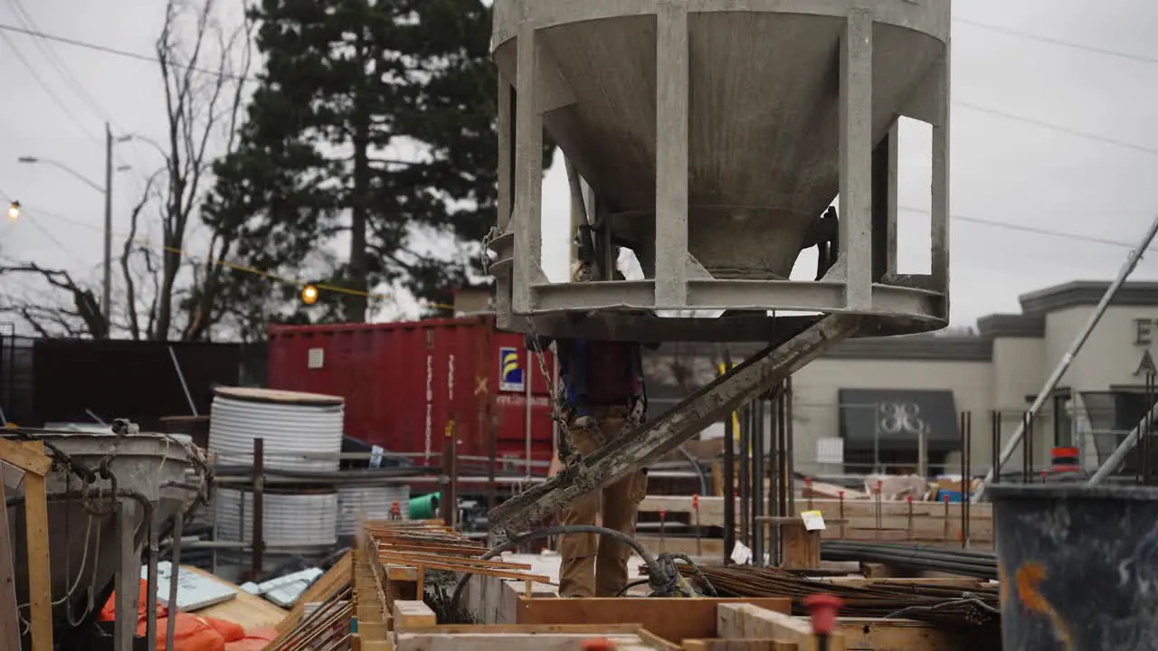 Construction worker pouring wet concrete at a construction site in Toronto Ontario Canada