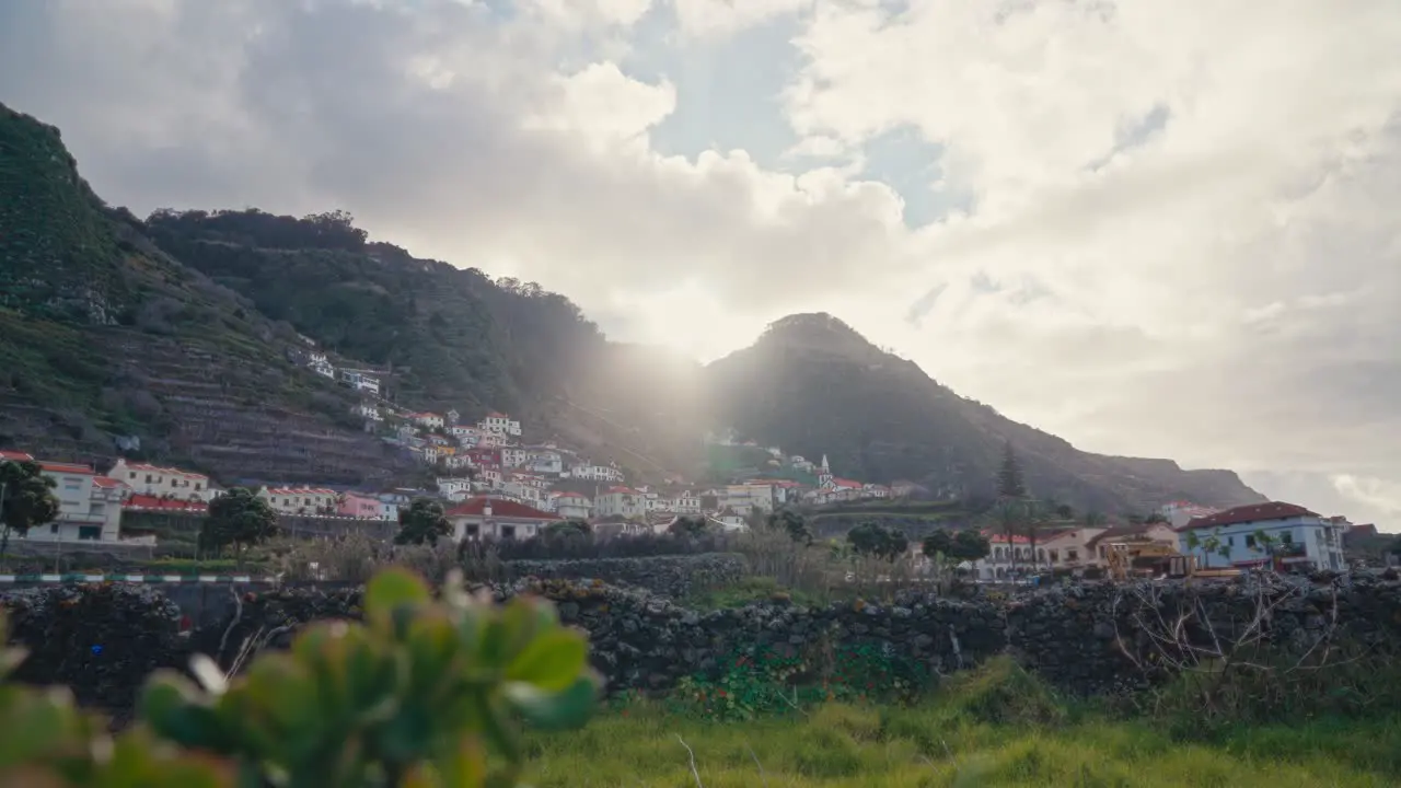 City built on the bottom of a mountain at Madeira at sunset