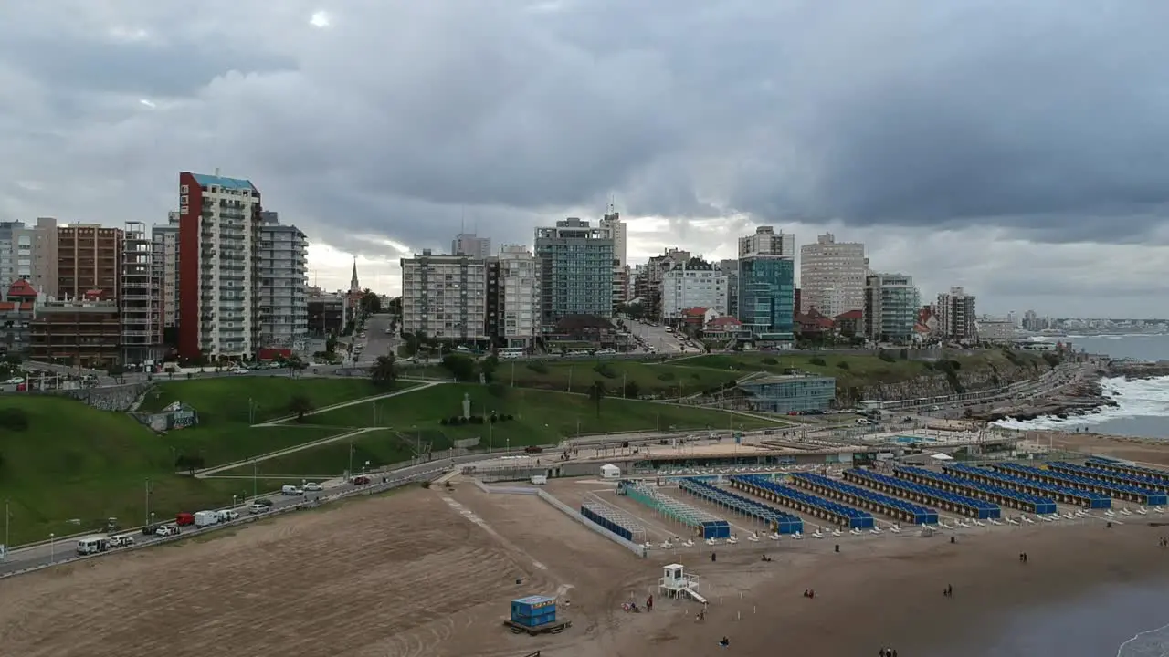 Drone 360° view of the city and the beach in a cloudy day