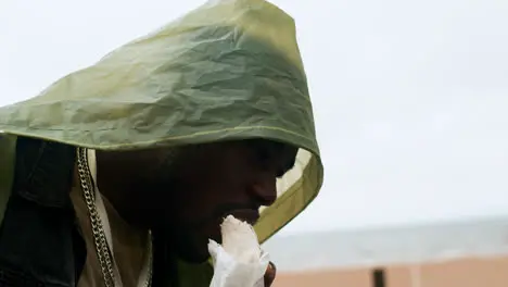 Man eating burrito on the beach