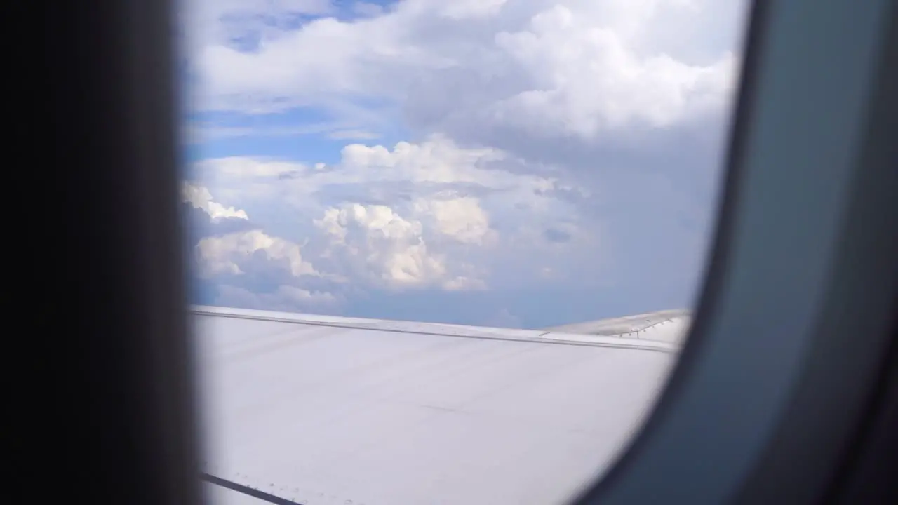 Looking outside airplane window flying through beautiful skies