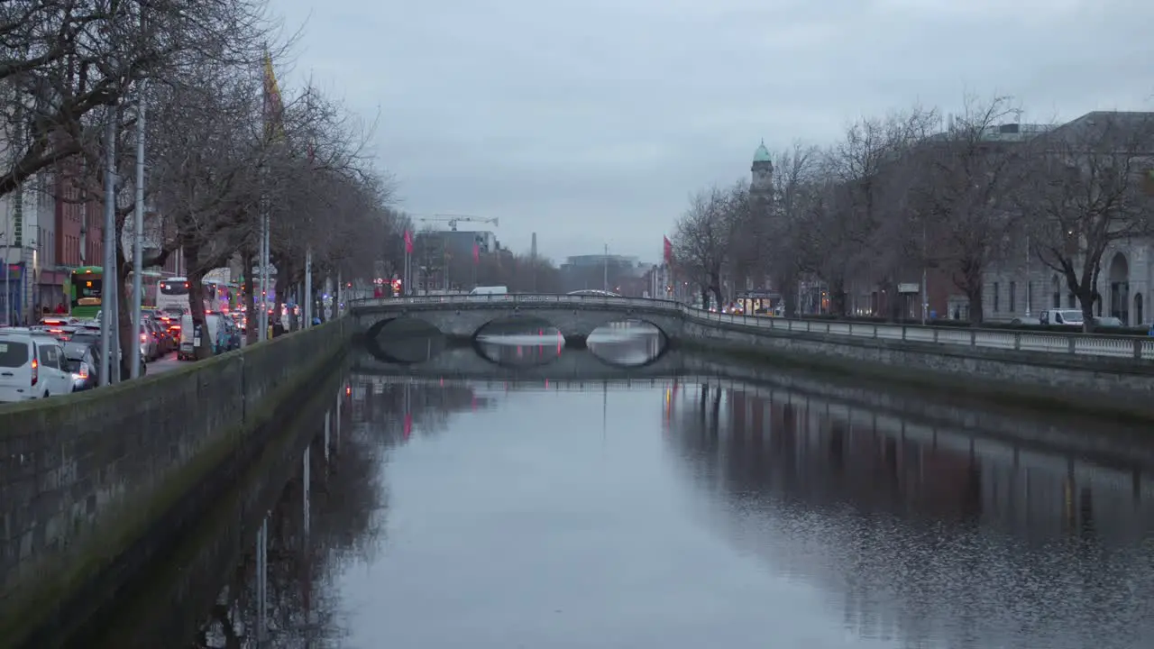 Liffey river in Dublin with Father Matthew bridge and city traffic