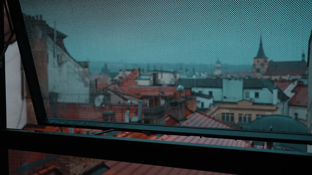 Raindrops Falling on a Glass Window in the City Center of Prague Czech Republic on a Cloudy Day with the City in the Background