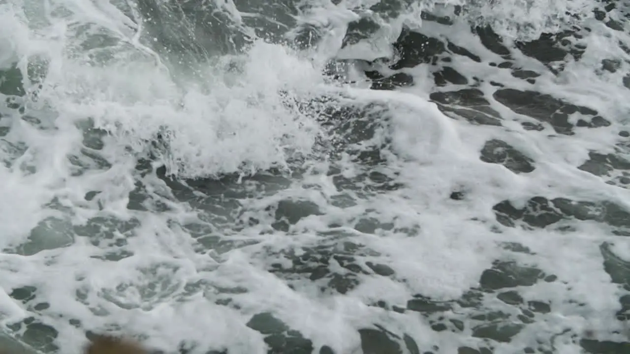 Slow motion of foam with waves crashing in it