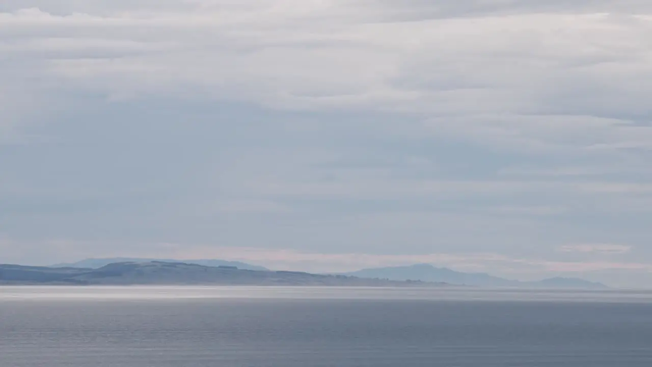 Beautiful New Zealand landscape with ocean and distant mountain