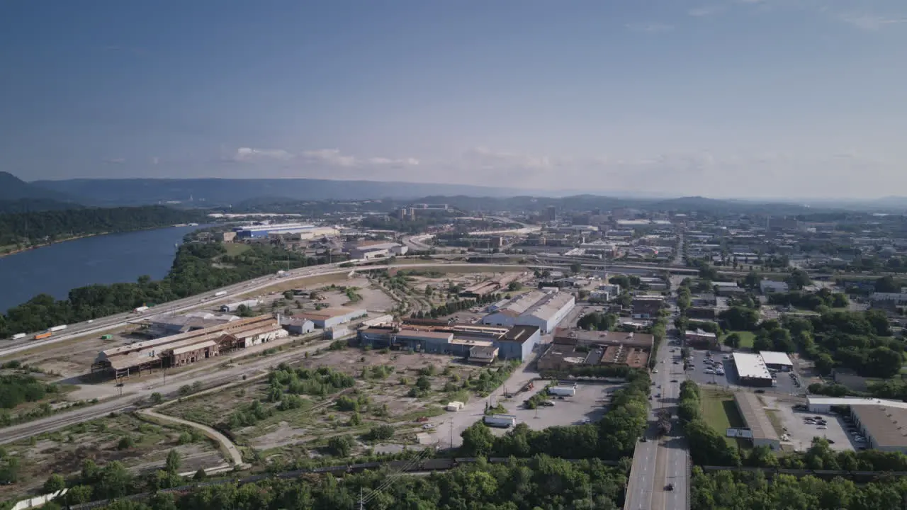 Aerial hyperlapse flying over Broad Street towards downtown Chattanooga with traffic speeding away on highway I-24