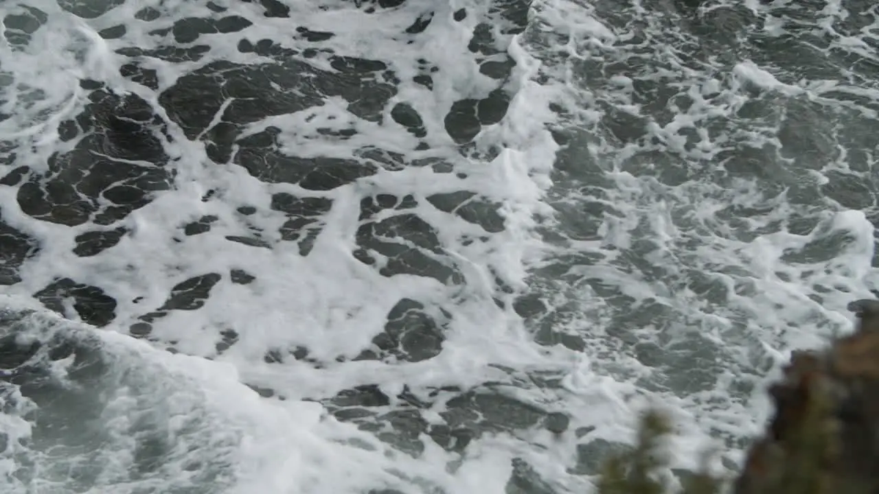 Slow motion of sea foam in medium shot