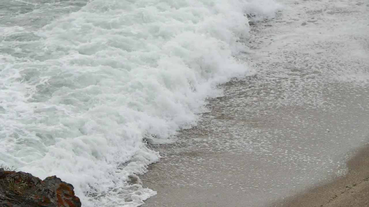 Wave foam with tele lens in slow motion