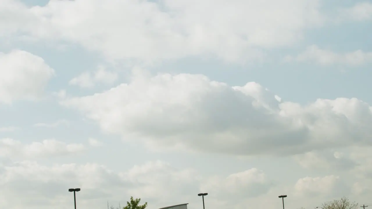 Big clouds moving after a storm in a parking lot