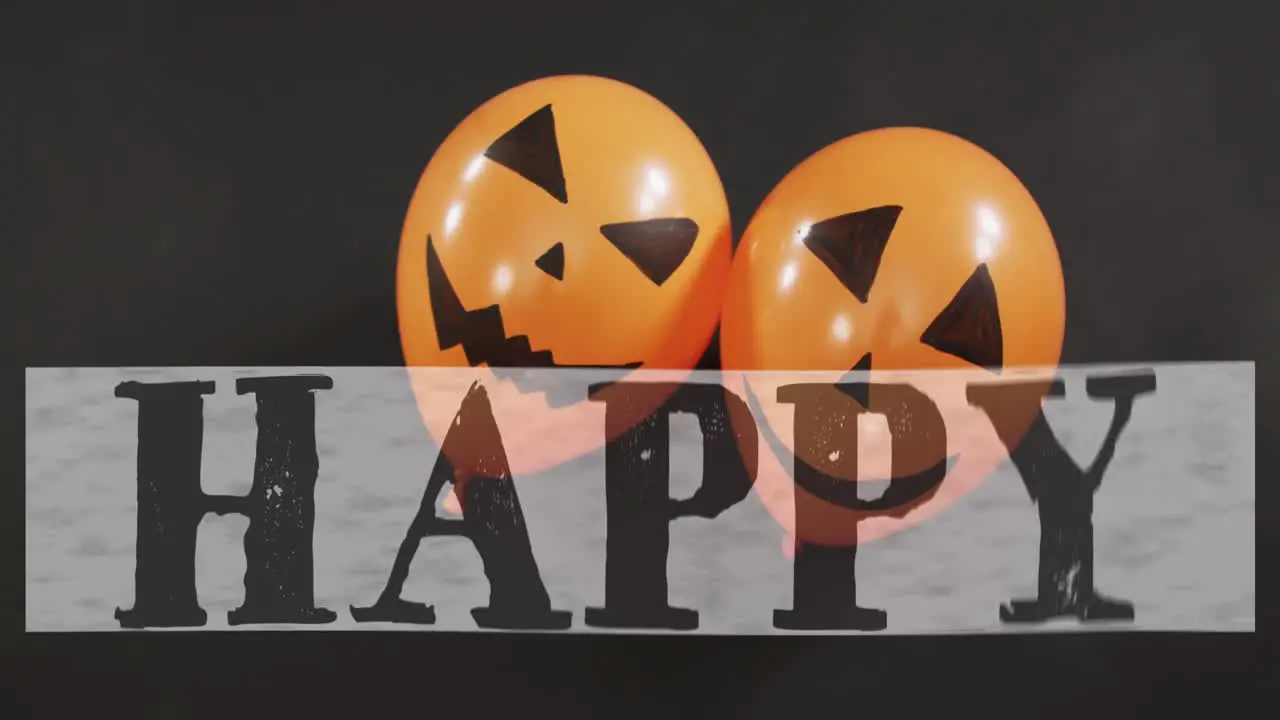 Happy halloween text banner over two halloween pumpkin printed balloons against black background