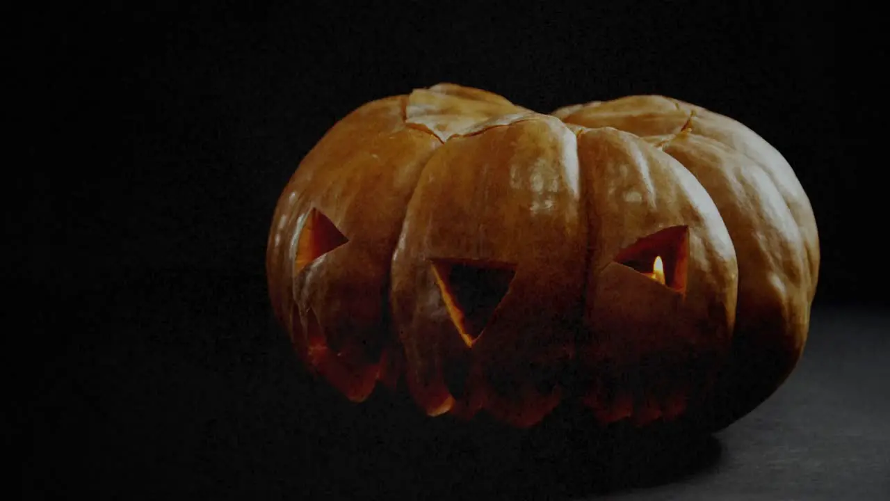 Animation of jack o lantern halloween pumpkin on black background