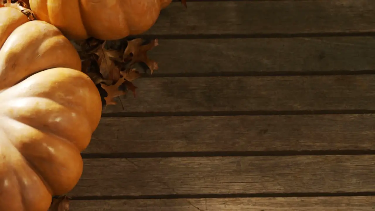 Halloween pumpkin with maple leaf on a wooden table 4k