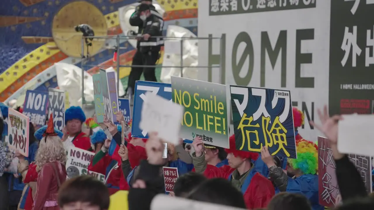 Japanese People Holding Placards To Protest Against Wearing Of Mask On Halloween Night In Shibuya Halloween 2020 In Tokyo Japan close up slow motion