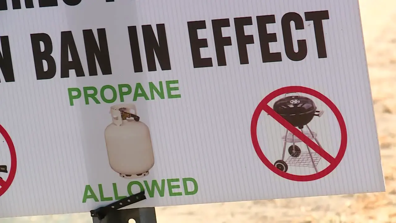 PANNING SHOT OF BURN BAN SIGN ALONG ROAD