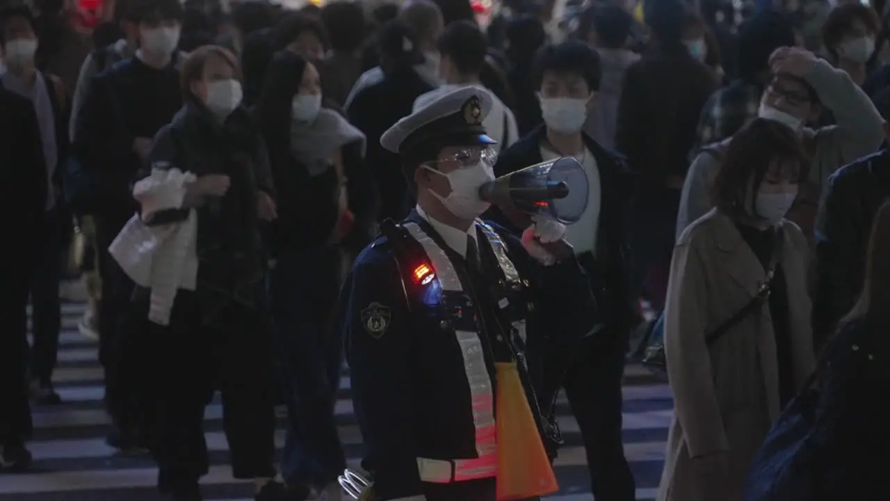 Policeman Speaking To The Crowd Using A Megaphone On Halloween Night At Shibuya Crossing In Tokyo Japan Slow Motion