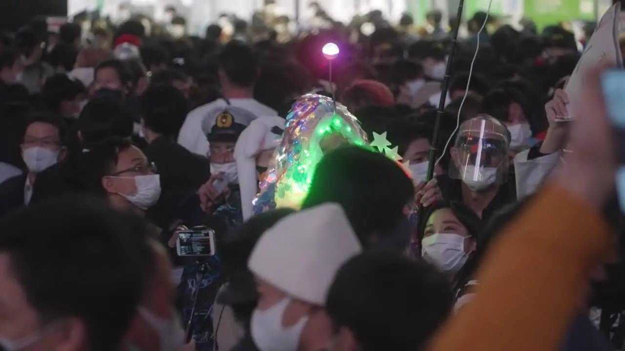 A Person Wearing A LED Halloween Costume Having A Selfie With A Young Girl On Halloween Night At Shibuya Crossing In Tokyo Japan Medium Shot