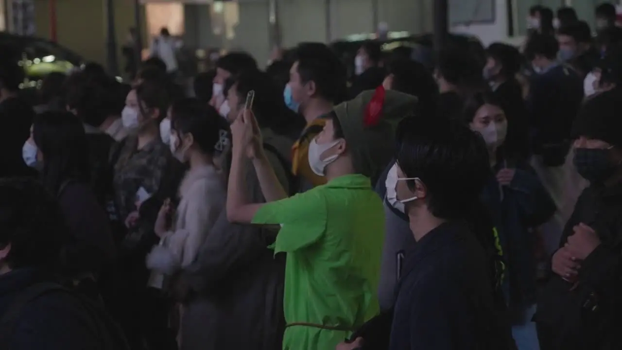 Japanese Guy In Robinhood Costume Taking Videos With His Cellphone At Shibuya Crossing During The Halloween Night 2020 Slow Motion